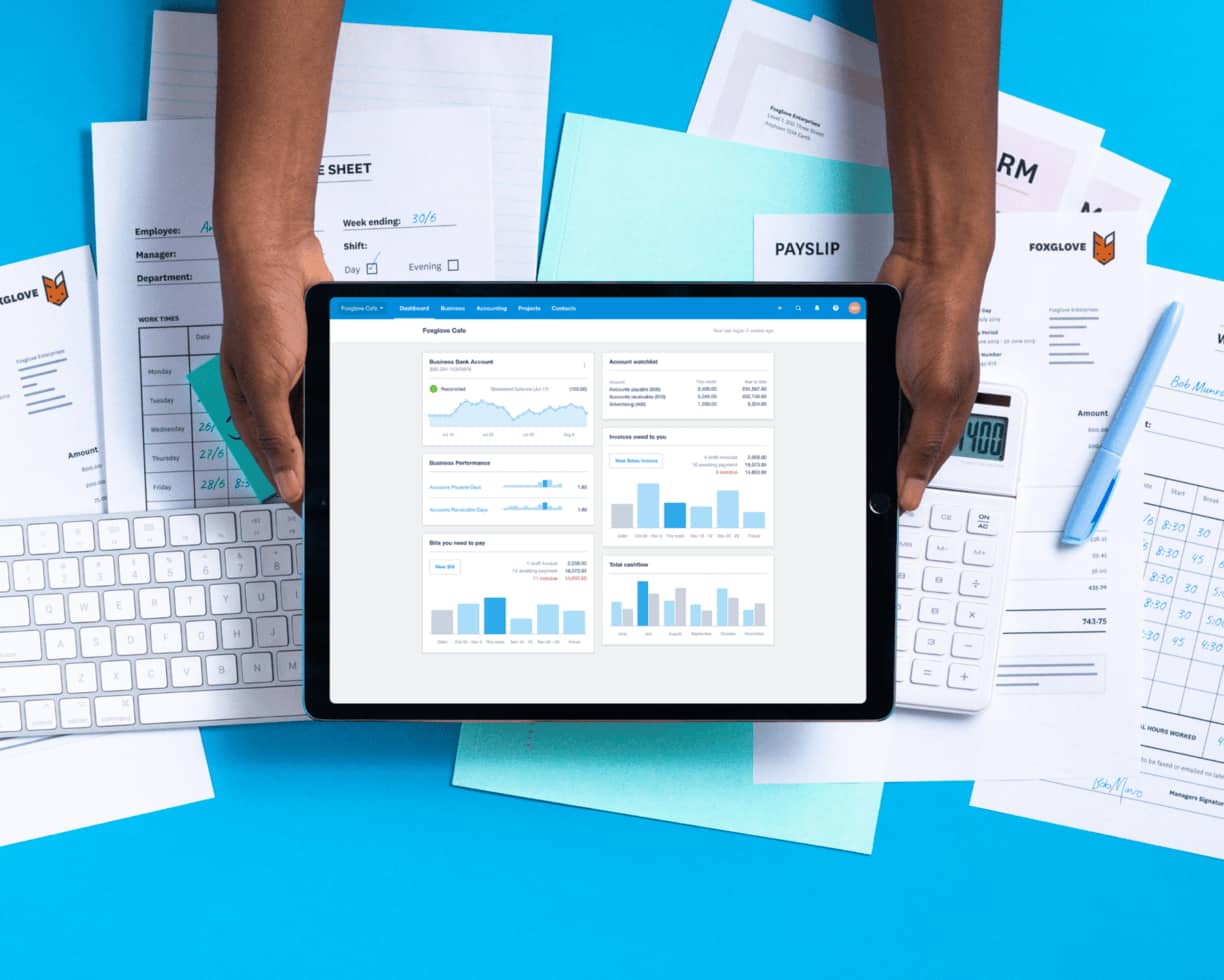 A tablet screen held to show the dashboard in Xero, a beautiful QuickBooks alternative.